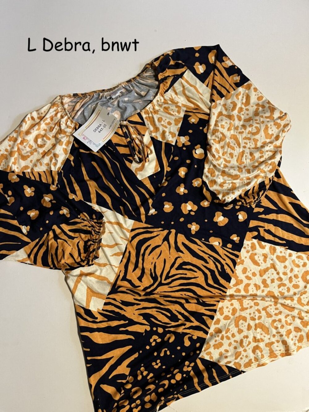Large Lularoe Debra peasant blouse, orange black animal patchwork